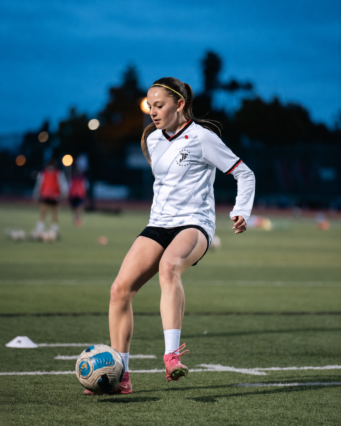 Young football player training with a ball