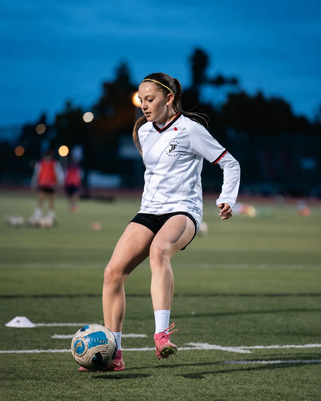 Young football player training with a ball