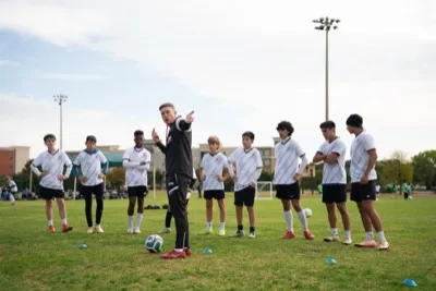 Coach Joner training players at football camp