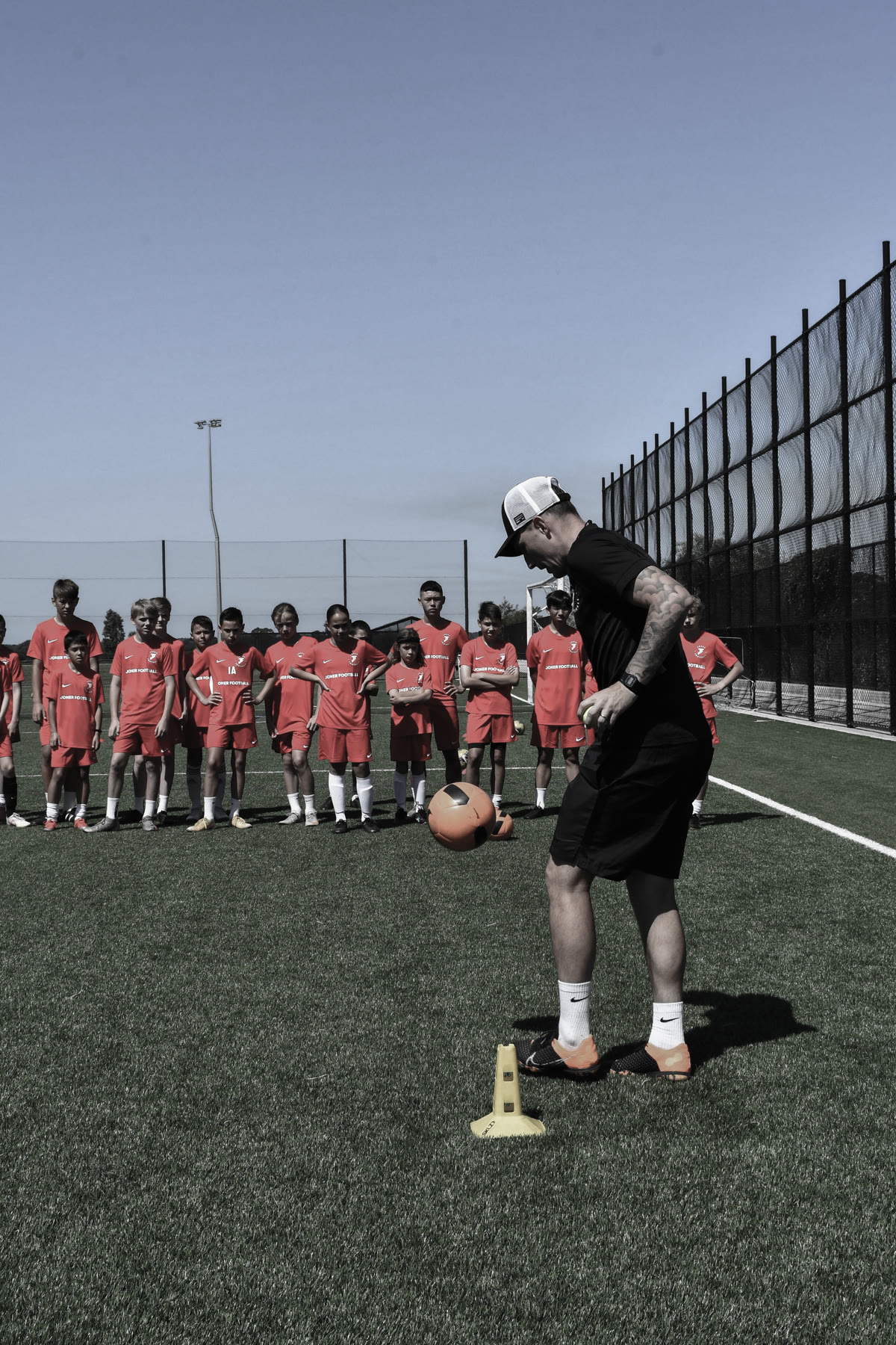 A young player training with the ball